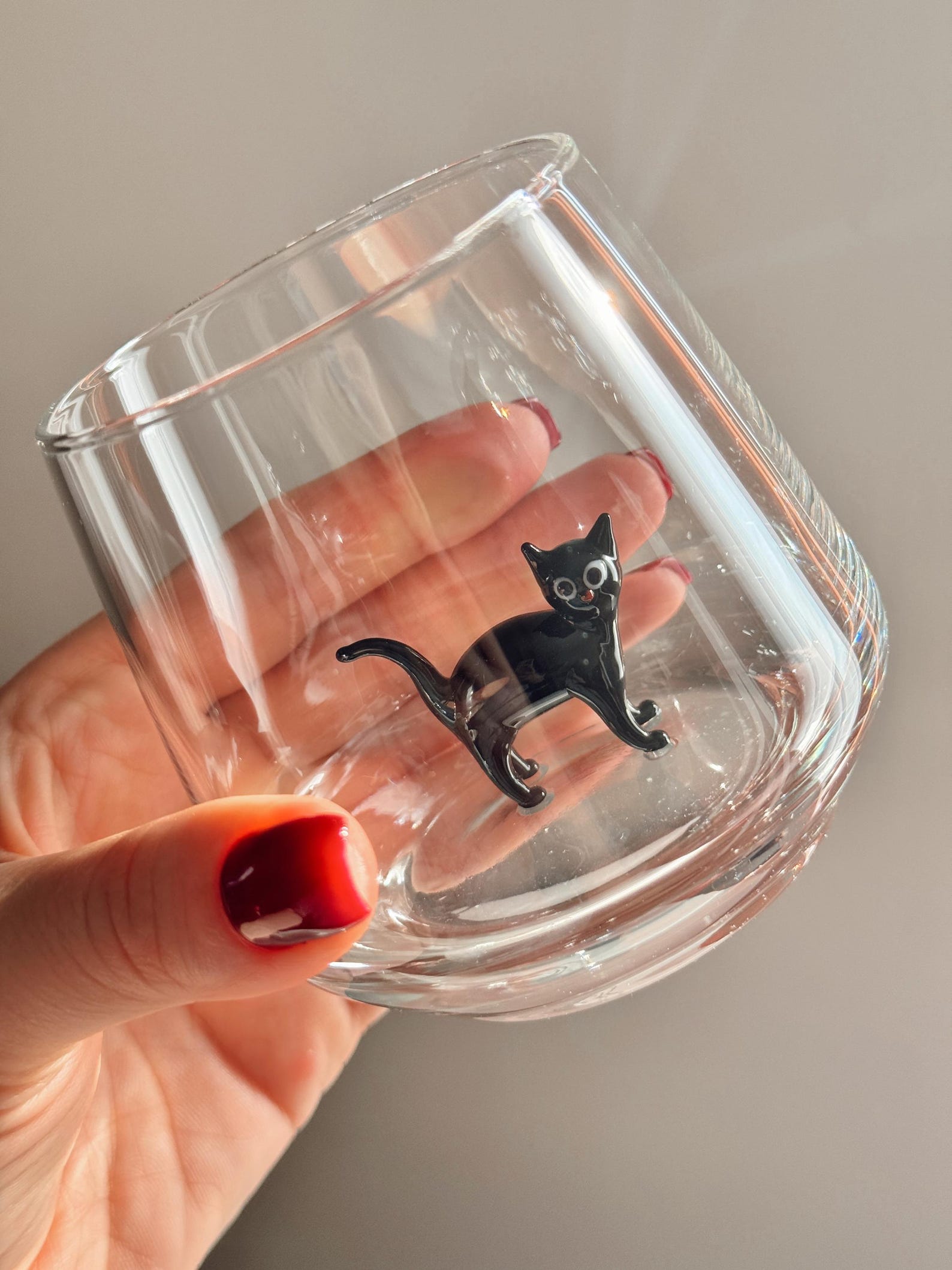 Murano cat glass on a cozy napkin, stage set for a drink
