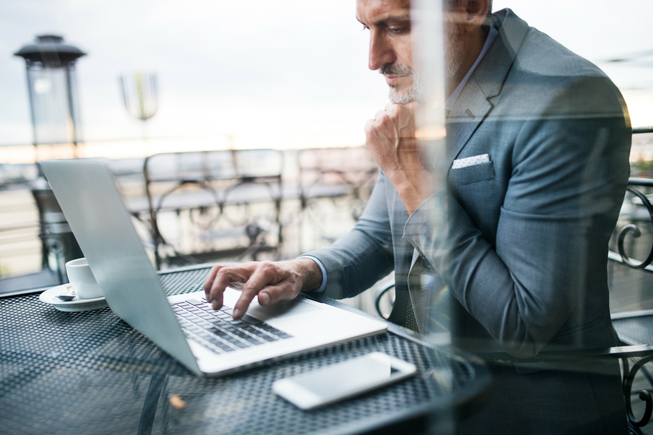mature businessman with laptop outside a cafe 2022 02 02 05 04 59 utc