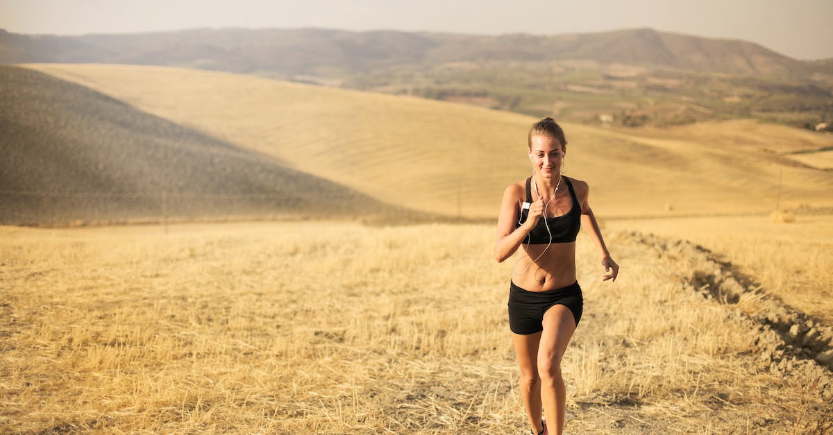 happy young woman running in field