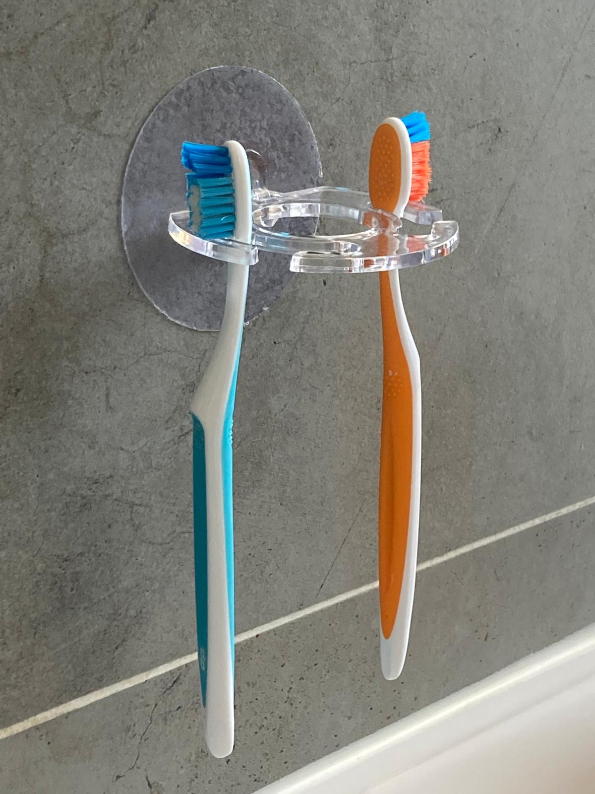 Porte-brosse à dents et dentifrice mural adhésif transparent discret brosse à dent bleu et orange.
