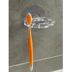 Porte-brosse à dents et dentifrice mural adhésif transparent discret brosse à dent orange.