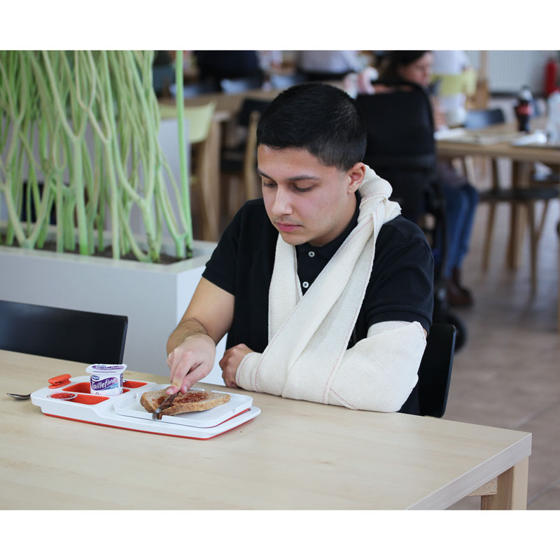 un-homme-avec-bras-dans-platre-coupe-sa-tartine-sur-planche-preparation-de-tartines-theomatik
