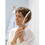une-femme-se peigne-les-cheveux-avec-brosse-cheveux-long-manche-etac-beauty