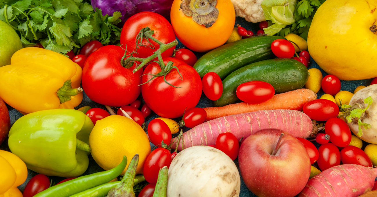 top view fruits vegetables eggplant bell peppers apples carrot coriander cauliflower persimmon radish cherry tomatoes blue background 1