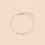 Bracelet Line argenté minimaliste avec zirconium rectangulaire et pierre lumineuse sur fond crème épuré