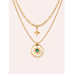 Collier Patti double chaîne dorée avec pendentif astral et pierre verte sur fond rose poudré minimaliste