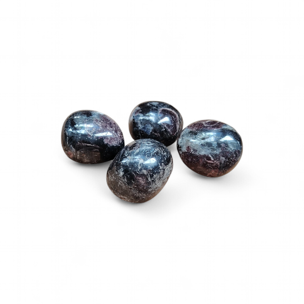 Quatre pierres roulées de grenat almandin rouge sombre sur fond blanc, reflets profonds et finition polie, pierres naturelles reliées à la vitalité, à l’assurance et à l’élan intérieur.