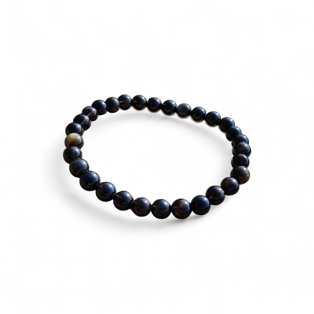 Bracelet obsidienne dorée 6 mm sur fond blanc, perles rondes noires aux reflets bronze, élégance minérale et recentrage
