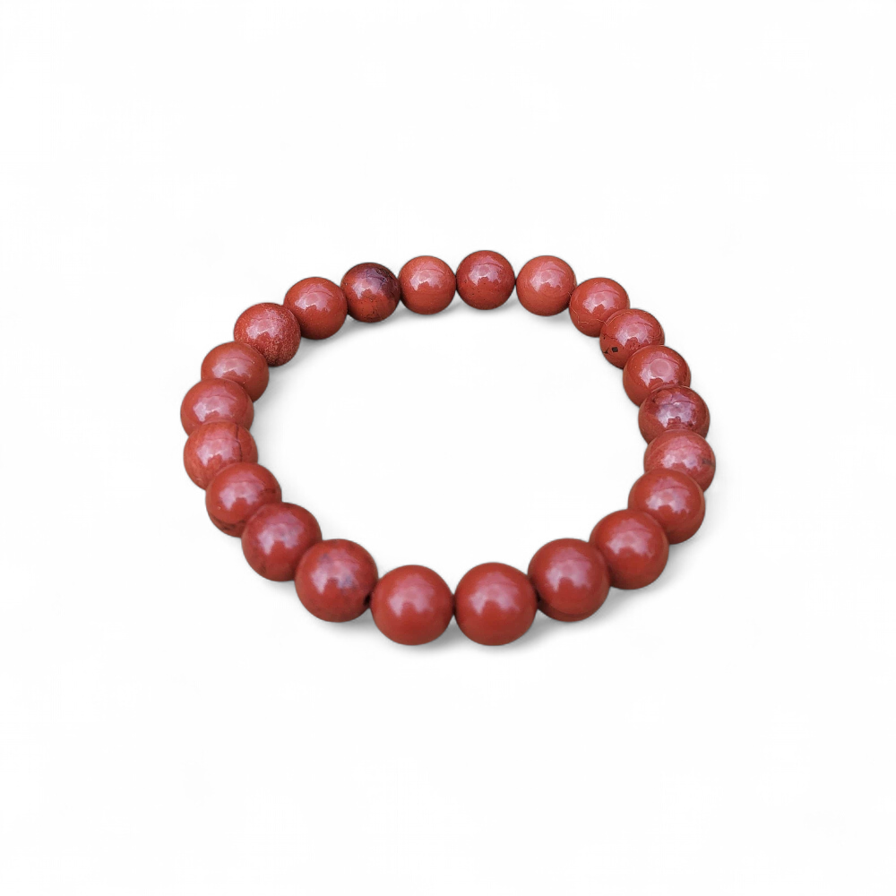 Bracelet jaspe rouge 8 mm sur fond blanc, perles rouge brique aux reflets naturels, ancrage, vitalité et force intérieure