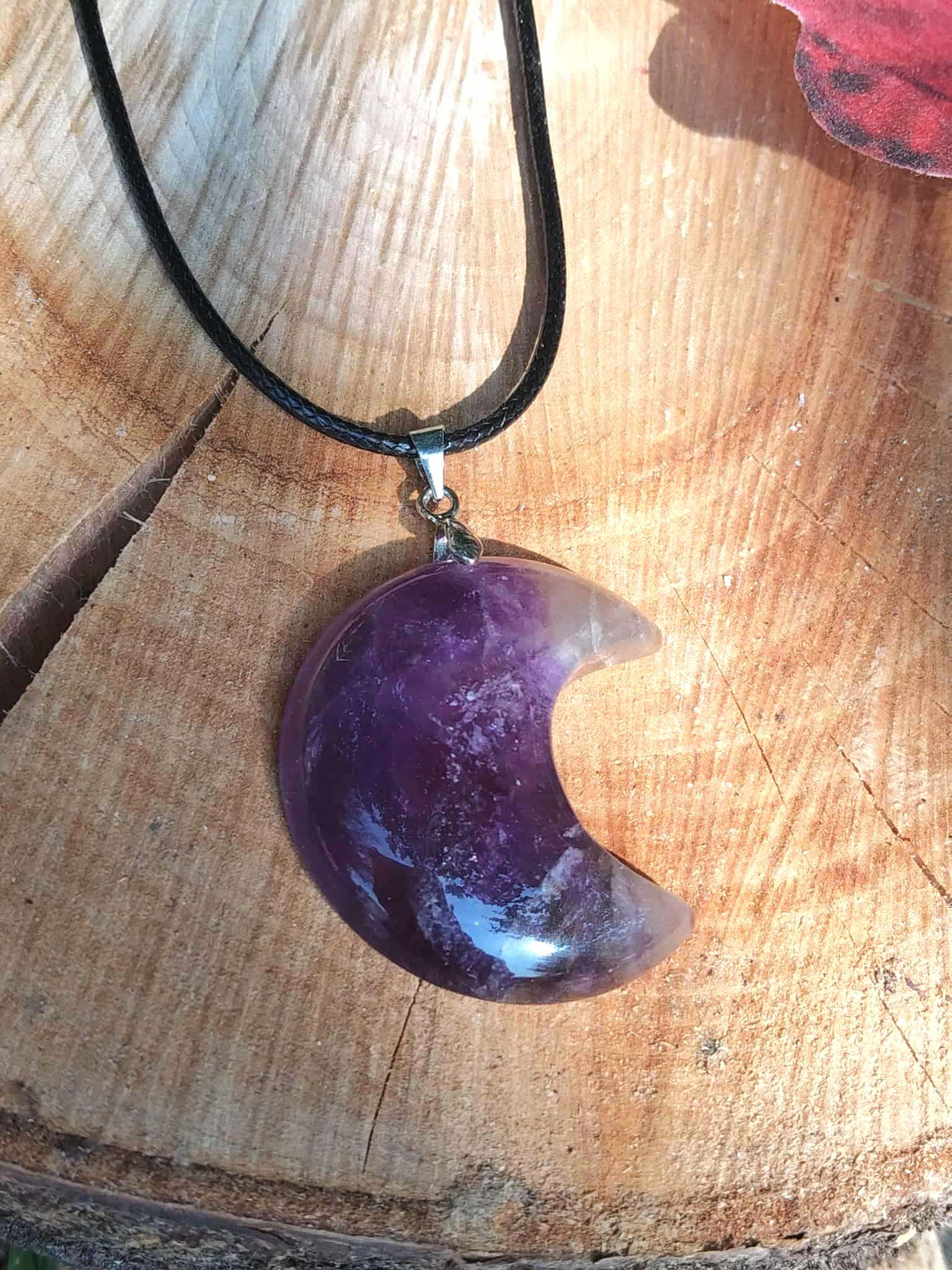 Pendentif lune améthyste violette sur bois clair avec décor rose, bijou de lithothérapie associé à la tendresse intérieure, à la sagesse et à l’apaisement des pensées.