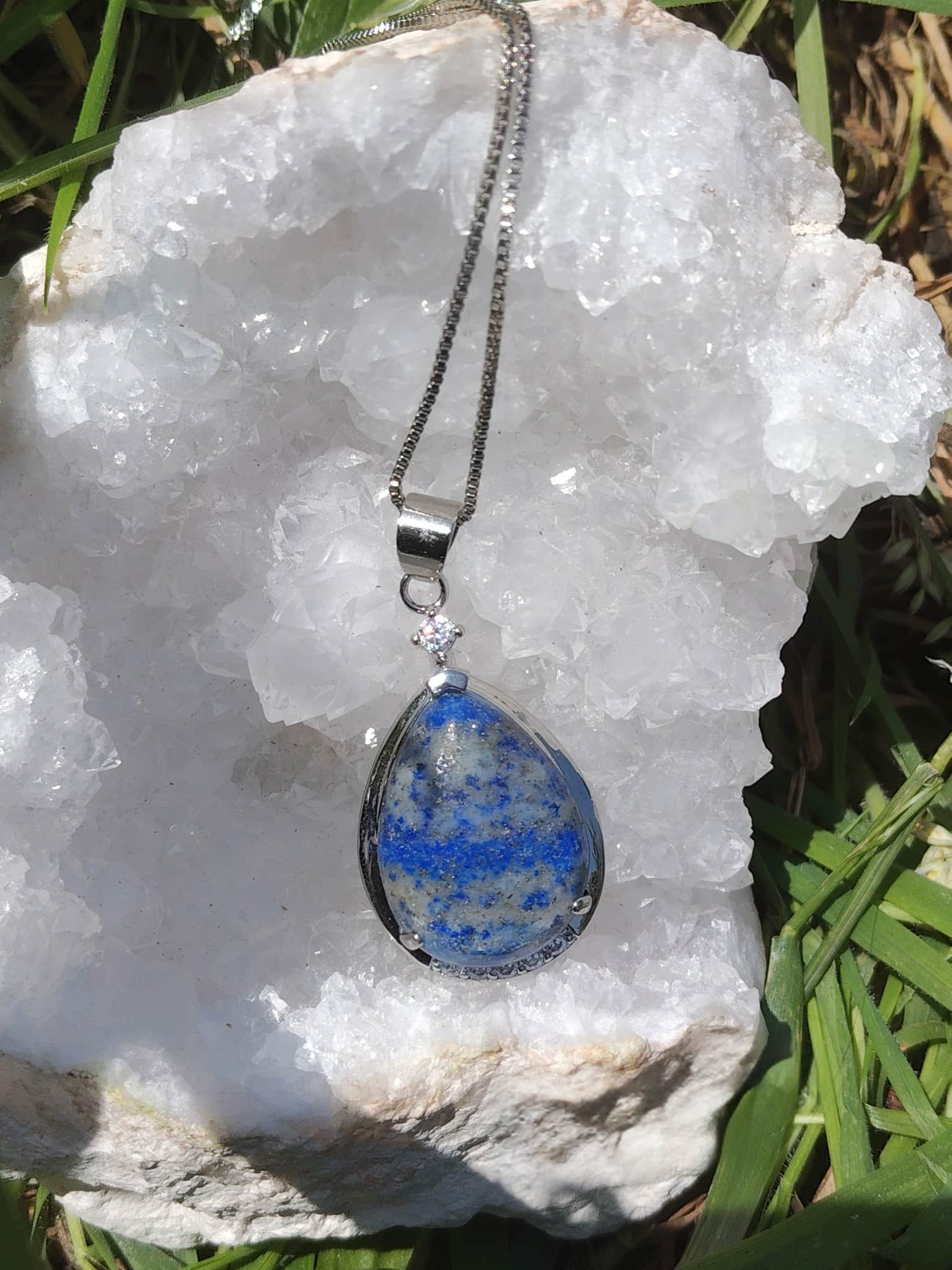 Pendentif goutte en lapis lazuli bleu sur géode blanche, chaîne réglable plaquée argent, bijou en pierre naturelle associé à la lucidité, à l’écoute intérieure et à la sérénité.
