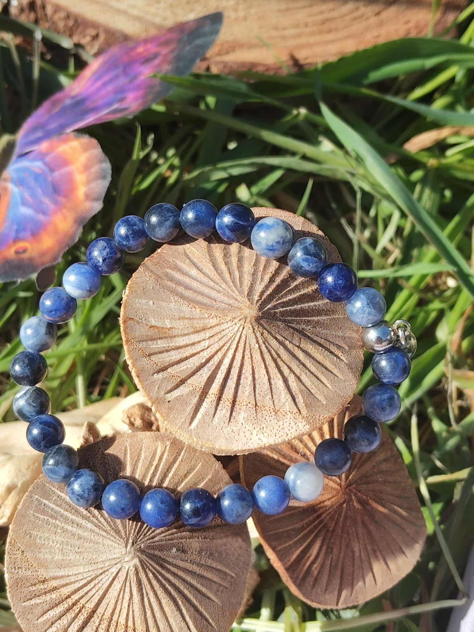 Bracelet sodalite bleue posé sur champignons en décor nature, pierre naturelle pour intuition claire, écoute intérieure et échange apaisé