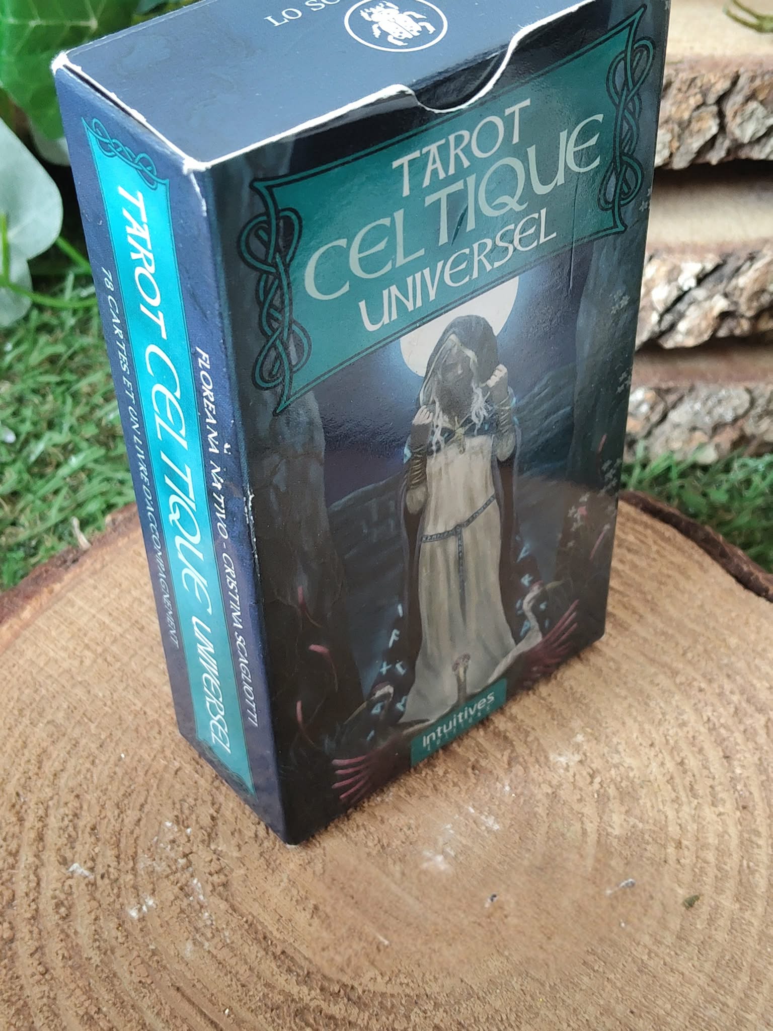 Tarot celtique – boîte du Tarot Celtique Universel vue en angle, mise en scène sur tranche de bois