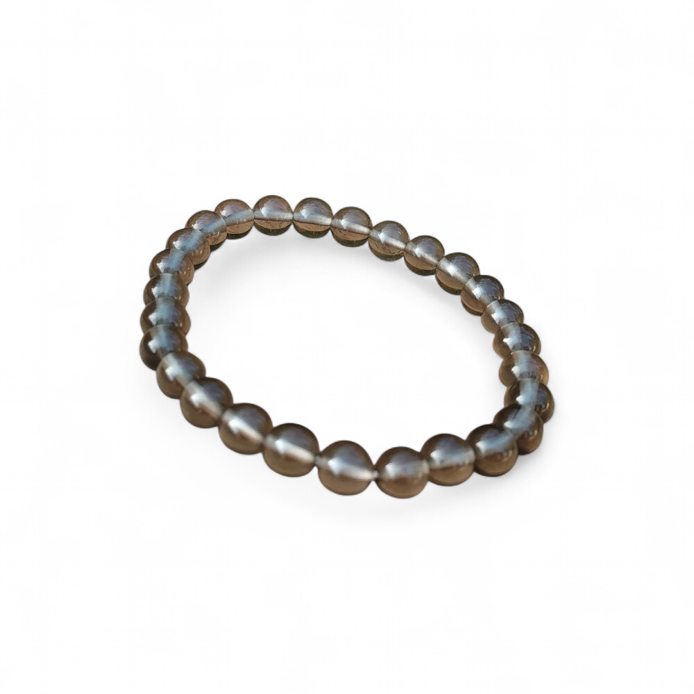 Bracelet obsidienne larme d’Apache sur fond blanc, perles noires 6 mm pour recentrage, stabilité intérieure et apaisement du ressenti