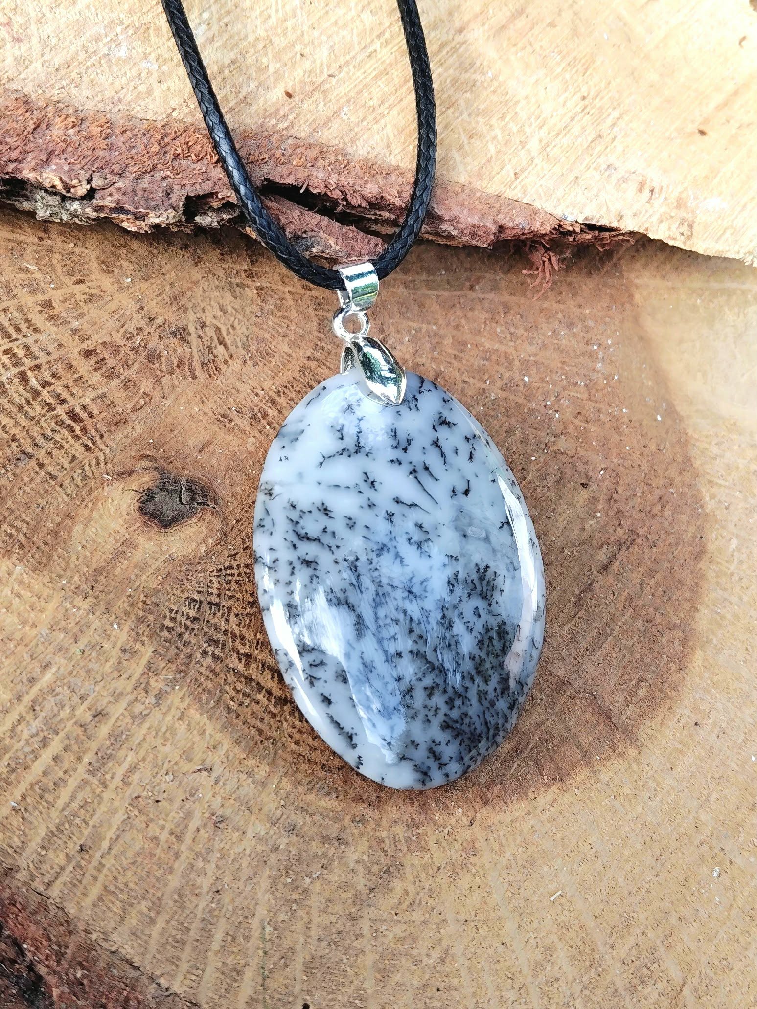Pendentif opale dendritique ovale sur bois avec cordon noir, pierre naturelle au style minéral pour recul émotionnel et réflexion claire