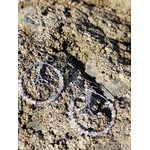 Boucles d’oreilles Hécate en fluorite, création Magic Gaïa, photographiées sur rocher breton aux textures brutes, pour clarté intérieure et apaisement.