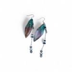Boucles d’oreilles fée création Magic Gaïa présentées sur fond blanc, avec ailes translucides bleu-vert, chaînettes fines et perles sombres, pour une allure féerique, délicate et pleine de douceur.