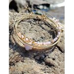 Bracelet semainier Love quartz rose en acier inoxydable sur rochers en Bretagne, bracelet féminin au design minimaliste