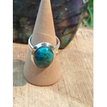 Bague chrysocolle argent 925 réglable sur cône en bois devant pierre sombre, cabochon bleu vert, douceur intérieure, expression sincère et sérénité.