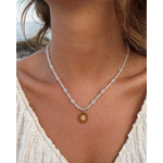 Collier Pierre de Lune porté au cou, pendentif soleil doré en acier inoxydable, reflets nacrés et style délicat.