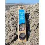 Encens AUM Organico Contre le Mauvais Œil 25 g posé sur rocher en bord de mer breton, ambiance rituelle naturelle.