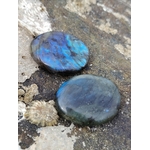 Galet labradorite polie présenté en ambiance naturelle, pierre aux reflets changeants pour sérénité et recentrage.