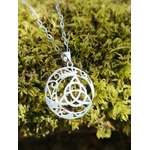Pendentif Triquetra Lune sur mousse verte, argent 925 lumineux avec croissant lunaire et entrelacs celtiques.