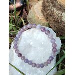 Bracelet tourmaline rose sur eudialyte posé sur géode de quartz avec décor végétal, harmonie du cœur et apaisement profond