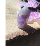 Pointe d’améthyste naturelle posée sur tranche de bois avec décoration papillon, cristal violet associé à la sérénité, à l’intuition et à la douceur intérieure.