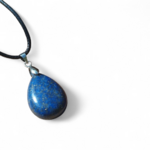 Pendentif goutte en lapis lazuli bleu sur fond blanc, bijou en pierre naturelle relié à l’expression sincère, au discernement et à l’harmonie émotionnelle.