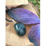 Pendentif agate mousse vert-bleuté sur cordon noir, photographié sur tranche de bois avec grande feuille violette, douceur du cœur et sérénité intérieure