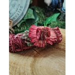 Smudge stick sauge   sang de dragon, fagot rouge ligoté, fleurs séchées, photo sur tranche de bois avec fond vert; idéal pour nettoyage énergétique, recentrage et clarté.