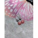 Boucles d’oreilles puces cornaline orange, tiges acier inoxydable, posées sur géode claire avec papillon rose en décor; énergie, vitalité et confiance.