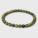 Bracelet péridot sur fond blanc, perles vert marbré et noires sur élastique pour optimisme, clarté émotionnelle et confiance tranquille