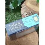 Coffret oracle « Le Tarot Psychique » de John Holland, boîte bleue vue de côté sur rondin de bois et mousse. Cartes, guidance, intuition.