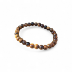 Bracelet Œil de Tigre 6 mm sur élastique, perles brun doré sur fond blanc, reflets miel lumineux, clarté mentale et stabilité intérieure.
