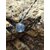 Collier Apatite en paillettes Création Magic Gaïa sur décor naturel breton, pendentif bleu argenté avec chaîne inox.