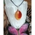 Pendentif Cornaline naturelle sur cordon noir, exposé sur une sélénite avec papillon, bijou énergétique pour vitalité, créativité et concentration.