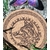 Dessous de plat rond en liège, loup gravé, bordure celtique; photo dans l’herbe, ombres de feuilles. Symbolique: instinct, protection, loyauté