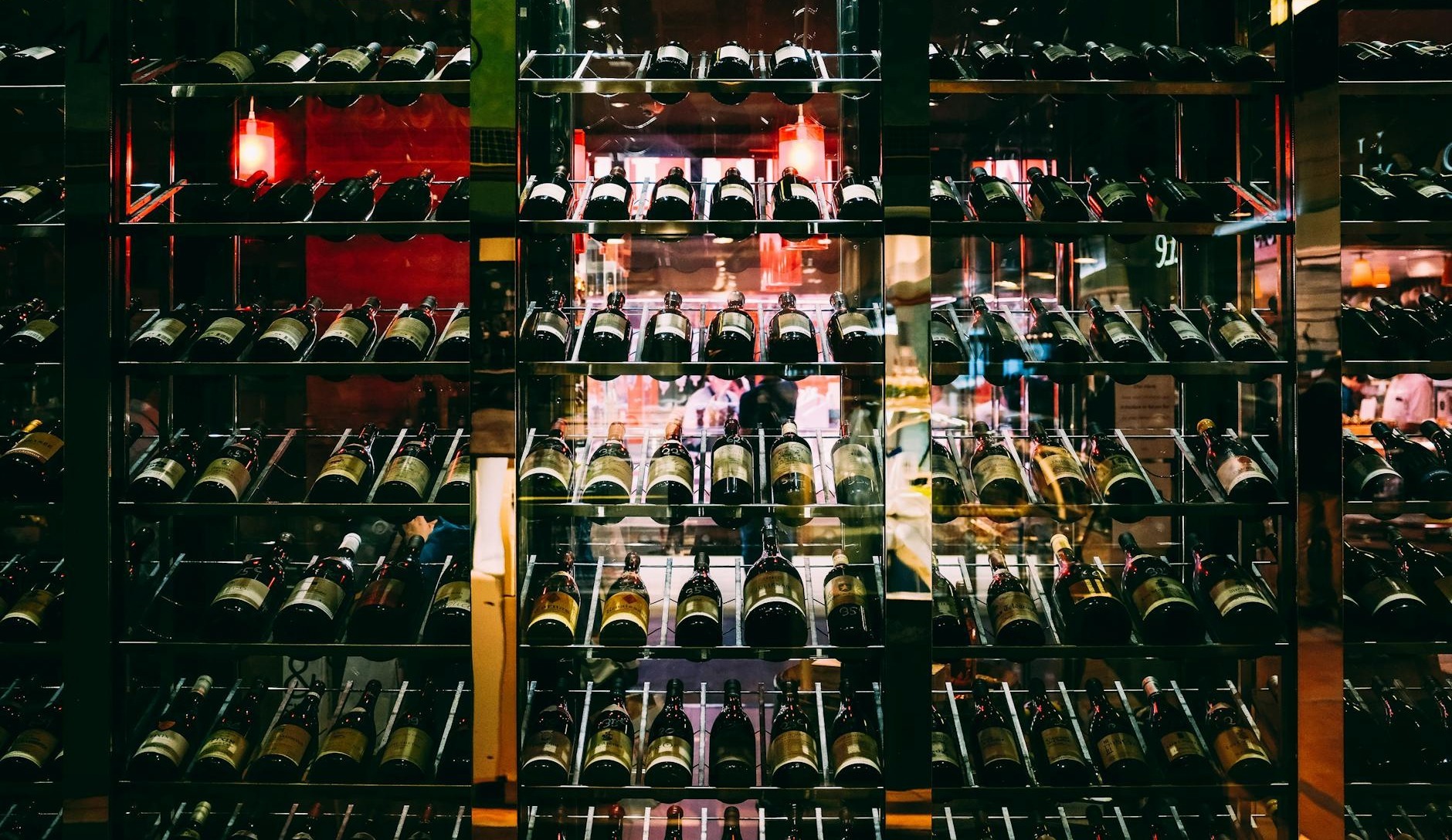 rows of wine bottles elegantly displayed on shelves at an upscale bar creating a luxurious ambiance
