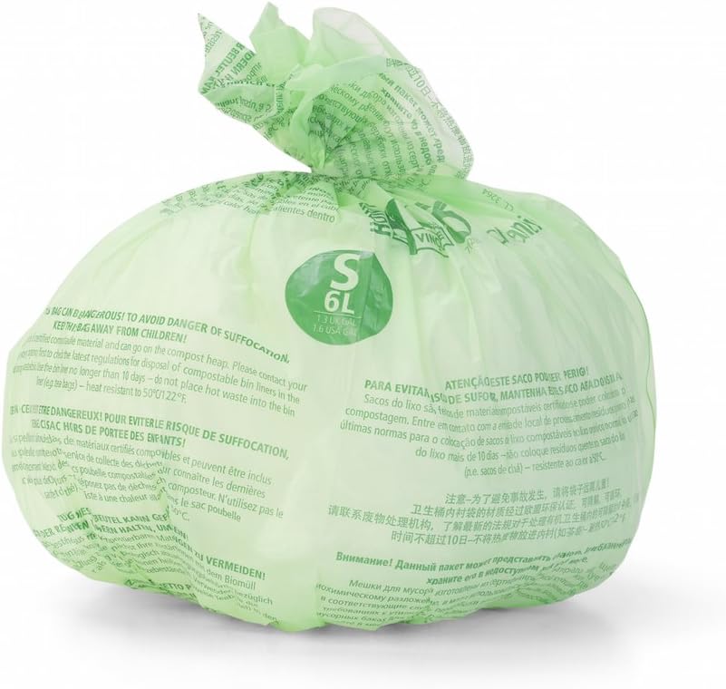 Second cliché du sac compostable vert noué, avec les consignes multilingues imprimées