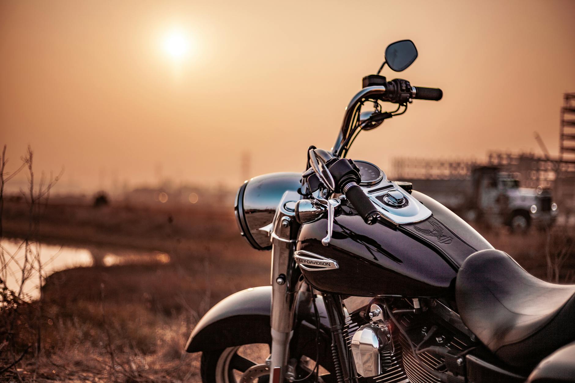 harley davidson motorcycle parked outdoors at sunset capturing the warm glow and serene environment