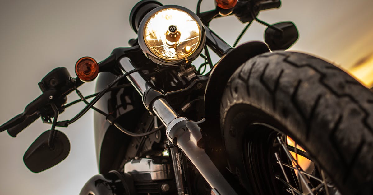 dramatic close up of a classic motorcycle s headlight with a low angle view at sunset