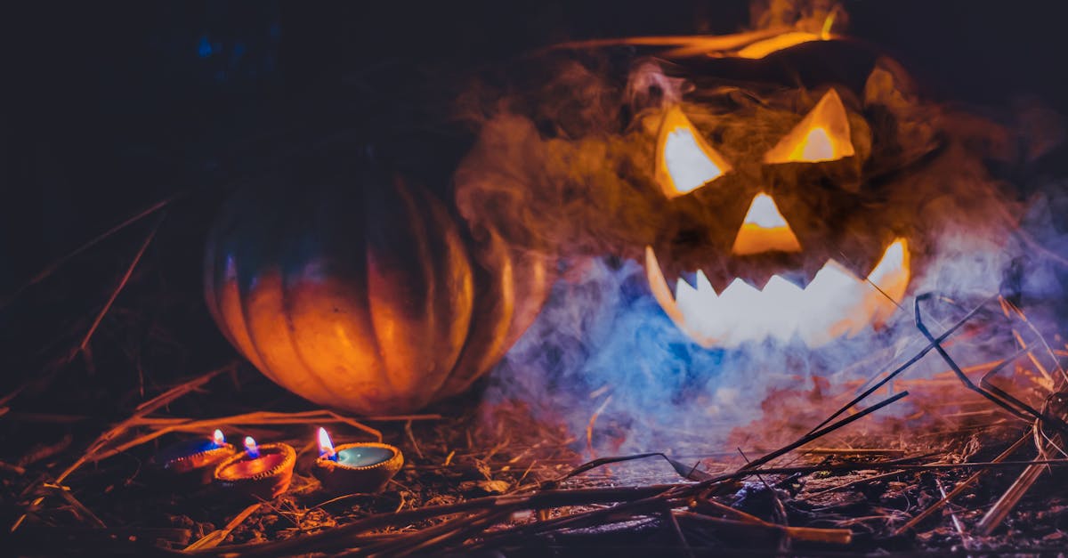 eerie jack o lantern amidst fog and candles creating a spooky halloween atmosphere