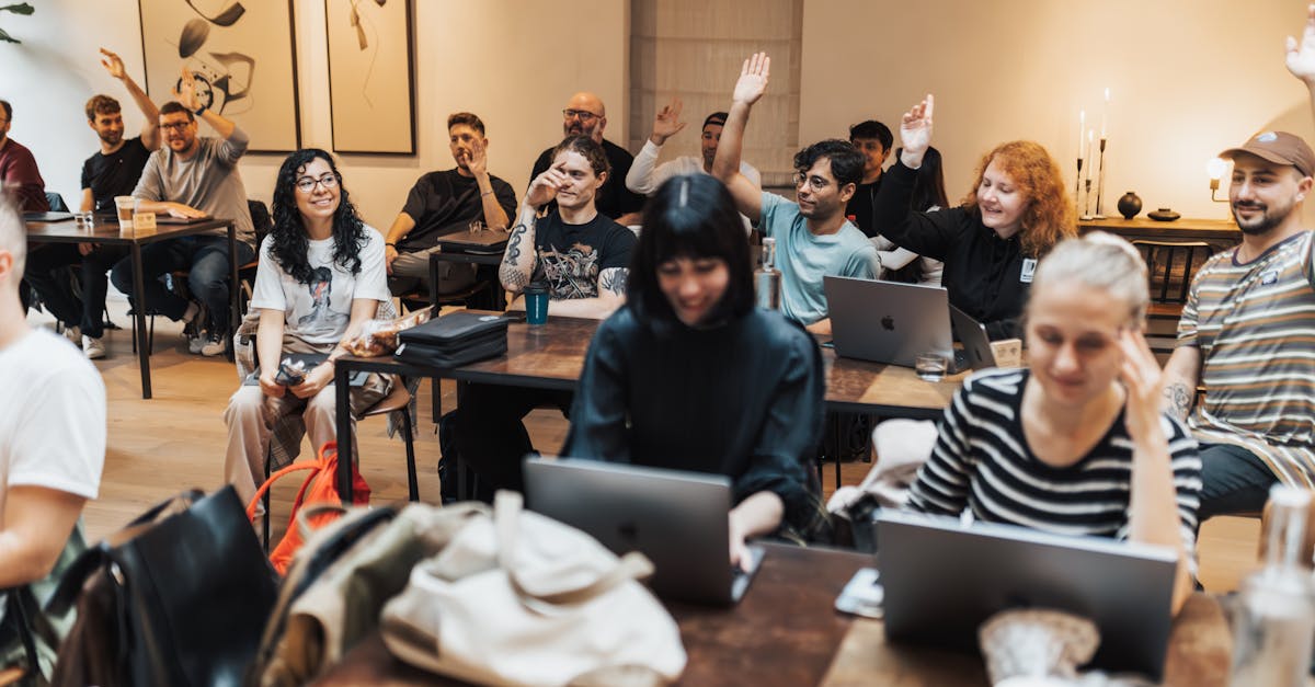 people sitting with arms raised in meeting in office