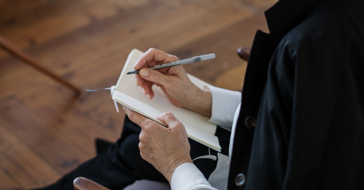 woman in black blazer holding white tablet computer