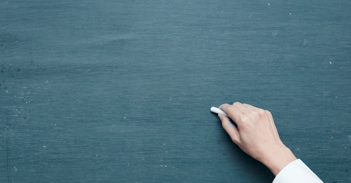 person holding white chalk