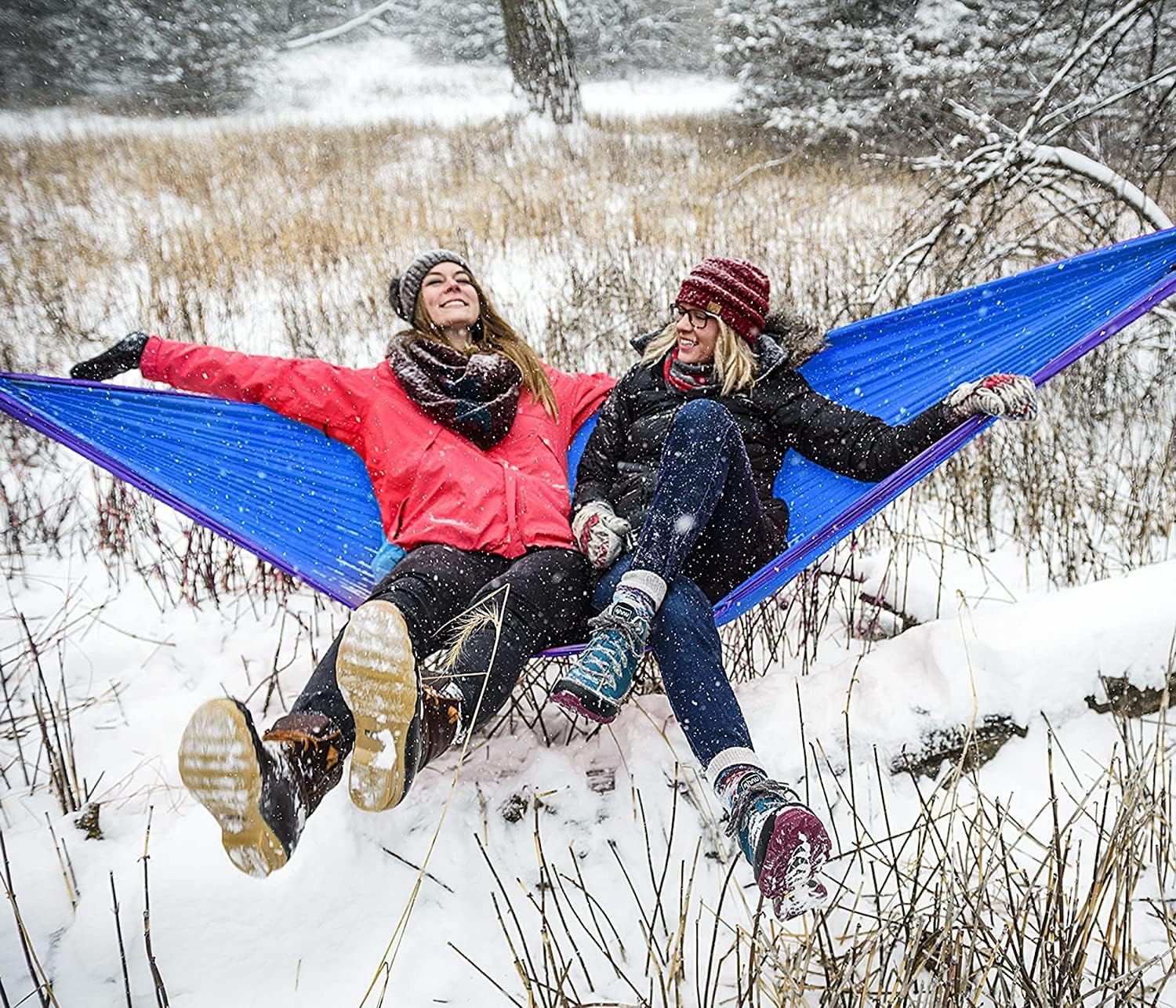 Eno DoubleNest Hammock – versatile for all seasons, shown in snowy outdoor setting with two people relaxing