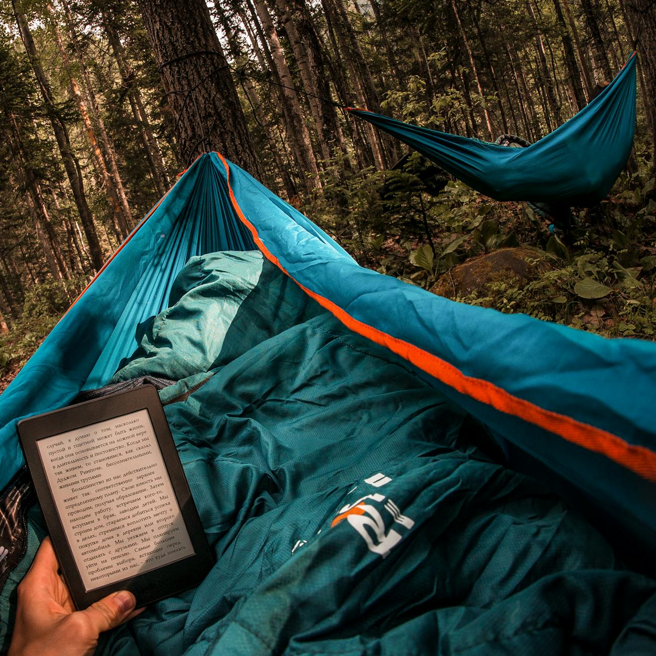 experience the tranquility of reading in a hammock amidst buryatia s lush forest