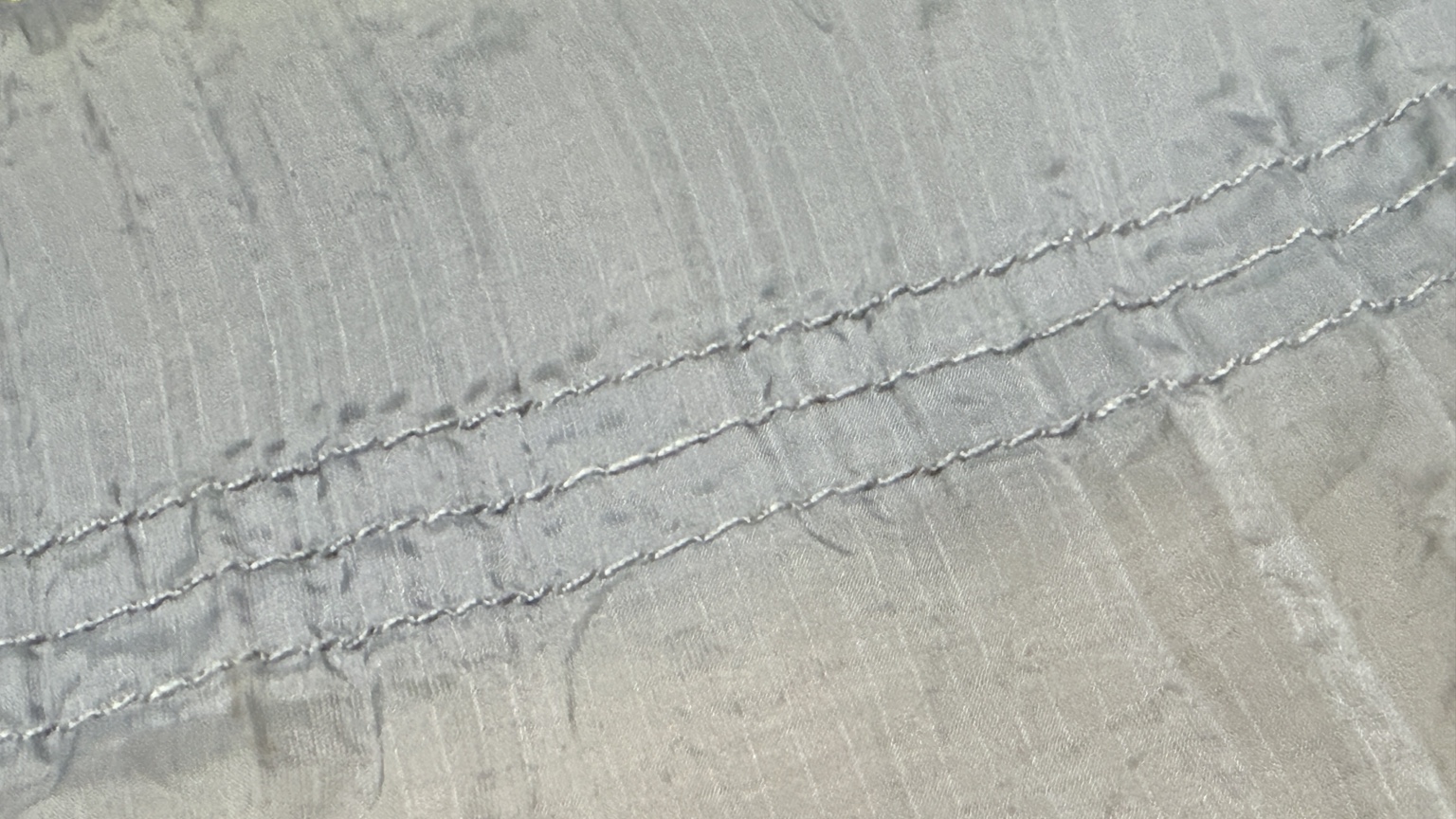 Close-up of three parallel stitch rows on Mike’s original gray Nano-7 hammock.